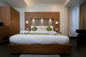 a bedroom with a large bed in a room at The Altruist Katra Hotel in Katra