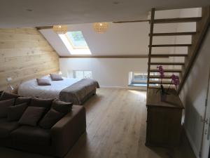 a bedroom with a bed and a ladder and a couch at Chante-Pierre in Gesves