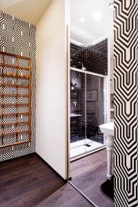 een badkamer met een douche en een glazen deur bij Arnobio Florence Suites in Florence