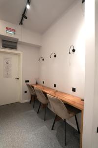 a conference room with a long wooden table and chairs at Aiva Hostel in Bishkek