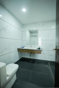 a white bathroom with a sink and a toilet at The Altruist Katra Hotel in Katra +87 photos