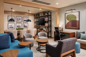 a living room with a couch and chairs at Hyatt Studios Kalispell in Kalispell
