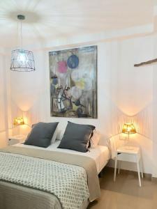 a bedroom with a bed and a painting on the wall at La Ballena del Charco in Arrecife