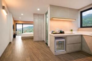 a kitchen with a sink and a bed in a room at La Cactus Oceanview Resort Quy Nhon in Quy Nhon