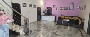 a woman is standing in a living room at Taj Guest House in Agra