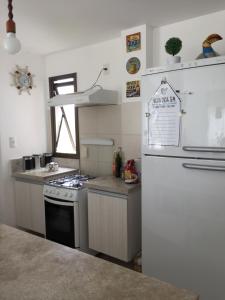 a kitchen with a stove and a refrigerator at Cond Mediterrâneo I - Iberostate in Praia do Forte