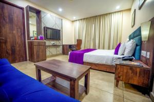 a hotel room with a bed and a table at Anna Residency The Quintessential Boutique Hotel in Pondicherry