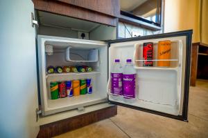 an open refrigerator filled with lots of drinks at Anna Residency The Quintessential Boutique Hotel in Pondicherry