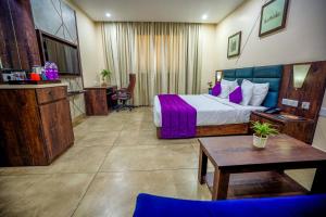 a hotel room with a bed and a table at Anna Residency The Quintessential Boutique Hotel in Pondicherry +54 photos