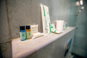 a bathroom counter with toothbrushes and other items on it at Anna Residency The Quintessential Boutique Hotel in Pondicherry