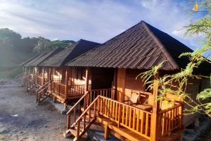a cabin in the woods with a roof at anisa homestay and restaurant in Ekas