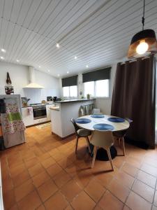 a kitchen with a table and chairs in a room at La petite Tourelle Ruelle de la Fontaine in Péronne