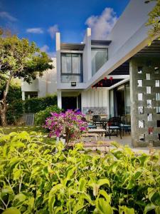 a house with a lot of plants in front of it at 719 - Villa Oceanami - Phước Hải in Long Hai