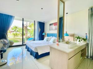 a bedroom with a bed and a sink and a mirror at 719 - Villa Oceanami - Phước Hải in Long Hai