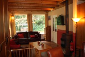 a living room with a couch and a table at Landhuis "Op de Heugte" in Norg