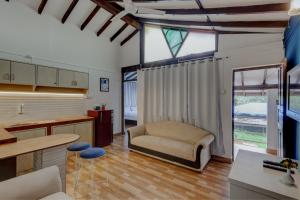a living room with a couch and a chair at Backspace Anjuna Beach in Anjuna