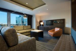 a living room with a couch and a chair at Hyatt Regency Dallas in Dallas