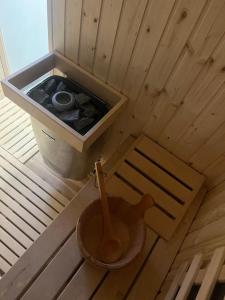 an overhead view of a sauna with a bucket and a wooden spoon at The Valley Queens in Bovec