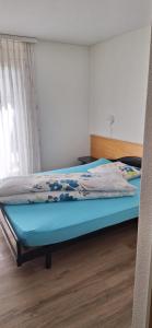 a bed with a blue mattress in a room at Gasthof Moosmatt in Egolzwil