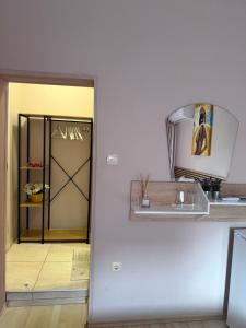 a room with a door and a room with a shelf at Guest house “Poli” in Nesebar