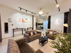 a living room with couches and a fireplace at Kulim Modern Bungalow in Kulim
