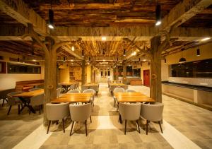 a dining room with wooden tables and chairs at Resotree in Talai