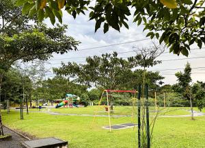 a park with a swing set and a playground at Kulim Modern Bungalow in Kulim