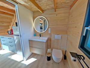 a small bathroom with a sink and a mirror at La Parenthèse Romantique in Saint-Martin-de-la-Mer