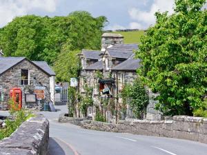 an old stone building on the side of a street at Artro View in Llanbedr