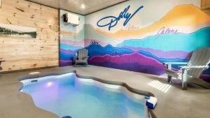 a room with a large mural on the wall at Jolene- Cabin Goals, Best Location, Pool & Hot Tub, Dogs! in Sevierville
