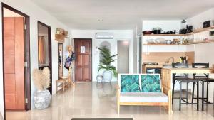 a living room with a kitchen and a dining room at Secret Place in Panwa Beach