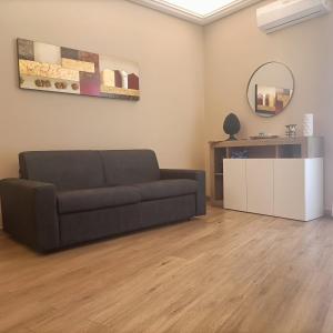 a living room with a couch and a mirror at Borgese Apartments in Palermo +41 photos