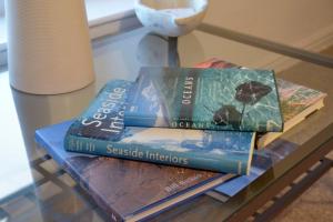 three books are sitting on a glass table at The Loft at Venga in Portishead
