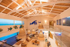 a house with a pool and a living room at Villa Tohora in Teavaro