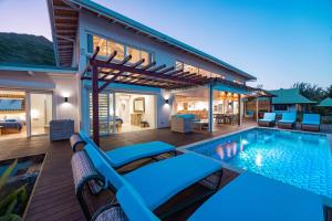 a villa with a swimming pool and a house at Villa Tohora in Teavaro