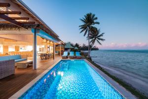 a swimming pool with a view of the ocean at Villa Tohora in Teavaro