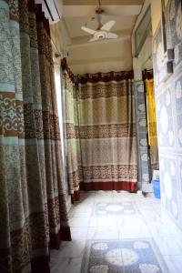 a room with curtains and a tile floor at Kompass - Home Stay in Dhaka