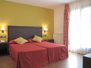 Voodi või voodid majutusasutuse Hotel Sesué toas