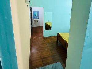 a bathroom with a sink and a bed in a room at Comforts Bhairavi INN in Kalyānpur