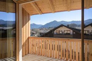 a view from the balcony of a house with mountains in the background at Alpensonne Apartments in Bad Wiessee