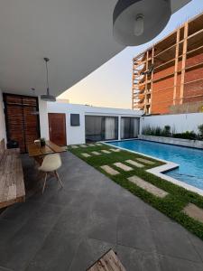 a courtyard with a swimming pool in a house at Coastal Beach Apartments in Maputo
