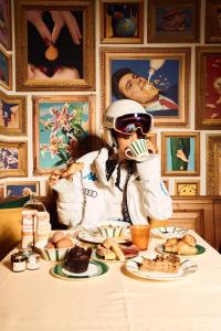 a woman eating food at a table at Ambra Cortina Luxury&Fashion Hotel in Cortina dʼAmpezzo