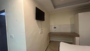 a small room with a tv on the wall at Jai Shree Hotel in Noida