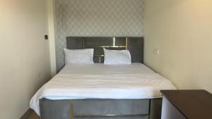 a bed with white sheets and pillows in a room at Jai Shree Hotel in Noida +9 photos