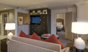 a living room with a couch and a television at Hyatt Regency Reston in Reston
