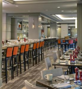 a restaurant with tables and chairs and a bar at Hyatt Regency Reston in Reston