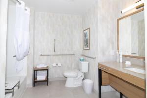 a white bathroom with a toilet and a sink at Hampton Inn Rock Springs in Rock Springs +14 photos