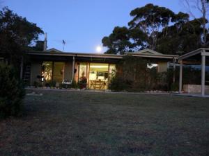 a house with a lawn in front of it at The Beach House, Kangaroo Island in Baudin Beach
