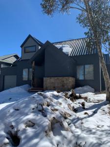 a house with snow in front of it at Keystone in Dinner Plain