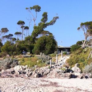 a house on a hill with rocks and trees at The Beach House, Kangaroo Island in Baudin Beach